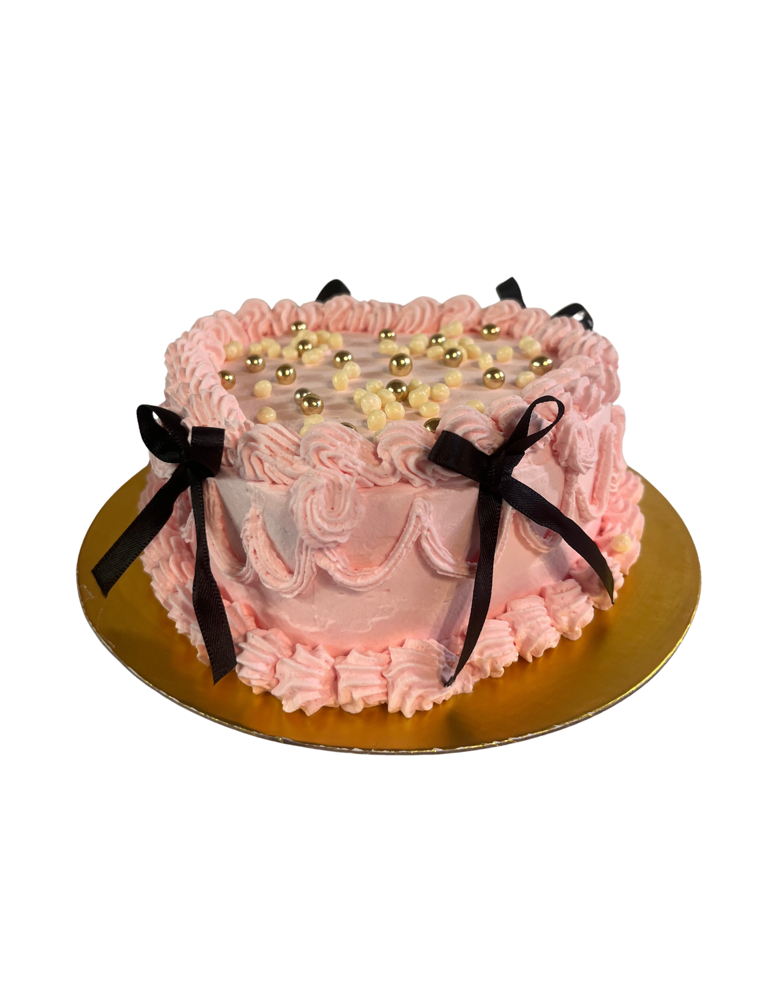 Gâteau rose vintage avec nœuds noirs et perles dorées